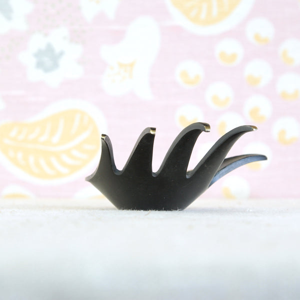 Detail of outstretched hand ashtray by Walter Bosse, with the extended thumb designed to support a cigarette.