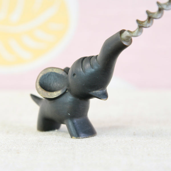Close view of the black-patinated brass elephant, with the ears and toes polished to reveal the golden metal beneath.