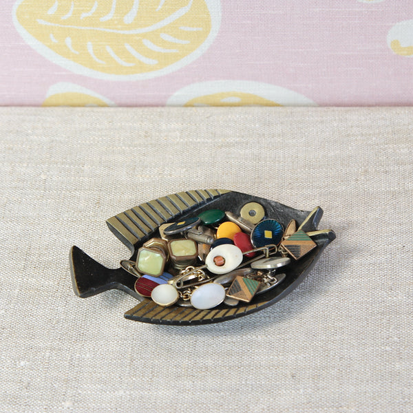 Collectable Viennese brass fish dish by Walter Bosse, combining Modernist simplicity with the designer's characteristic humour. Photographed containing a collection of vintage 1950's enamel and bakelite cufflinks. 