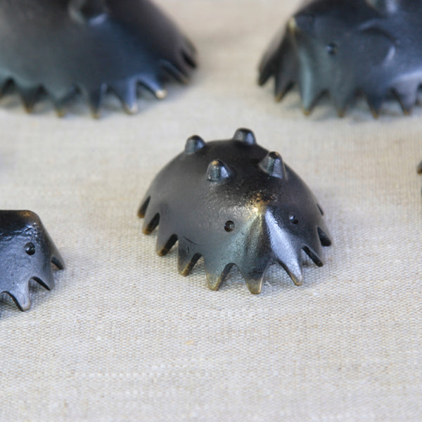Complete Walter Bosse hedgehog family in patinated brass, designed so the six individual pieces nest together when not in use.