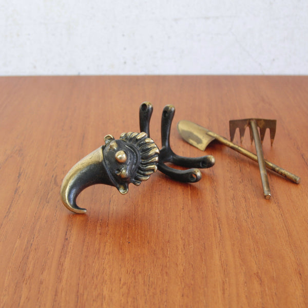 Deconstructed shot of a Walter Bosse brass garden gnome, playful bonsai figure for tabletop or shelf display.