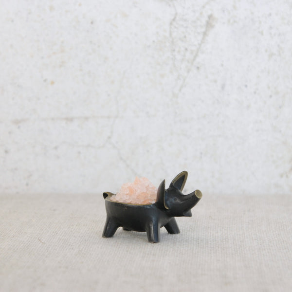 Sculptural brass pig vide-poche by Walter Bosse for Herta Baller, featuring refined black patination and hand-finished golden highlights.