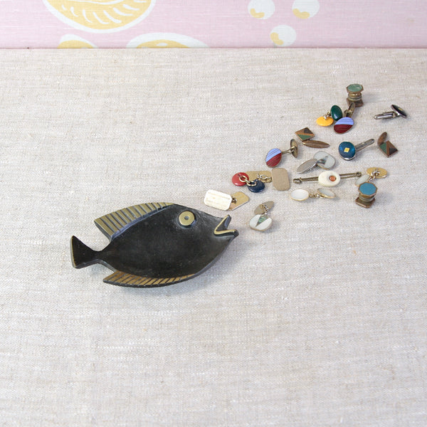 Walter Bosse fish-shaped tray in black and golden brass, produced by Herta Baller in post-war Vienna. Photographed with a collection of vintage Modernist cufflinks.