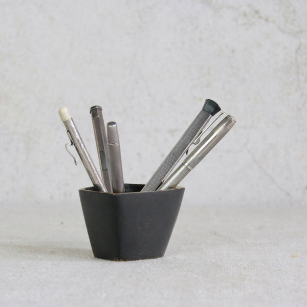 A sculptural Walter Bosse square brass vessel, pictured with silver antique pens, designed in Vienna during the 1950s.