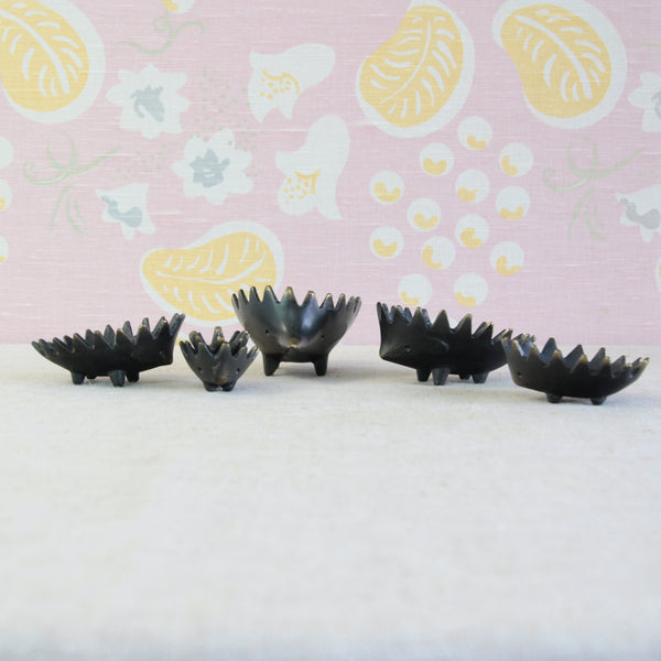 Walter Bosse black-patinated brass hedgehogs, originally conceived as individual smoking accessories for use around a table.