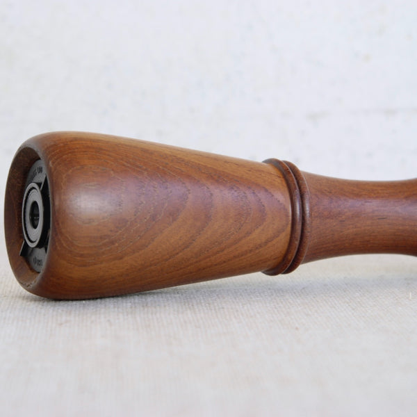 Close up showing the beautiful lively wood grain on a teak Jens Quistgaard Scandinavian pepper mill model 879 1960s vintage collectible kitchenware.