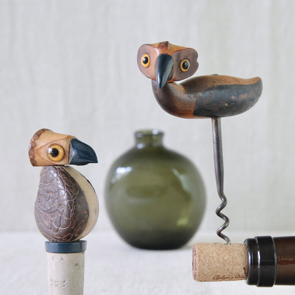 Close up of a Bernard Charles Howell YZ bird corkscrew and nut bird bottle stopper, both from 1925, combining carved wood, rattan, glass, Bakelite and steel.