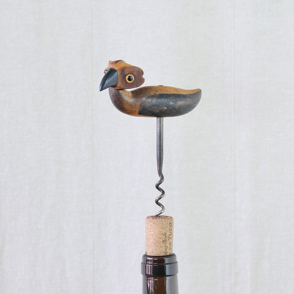 Art Deco YZ bird corkscrew showing its large navy blue Bakelite beak, glass eyes and characterful rattan head.