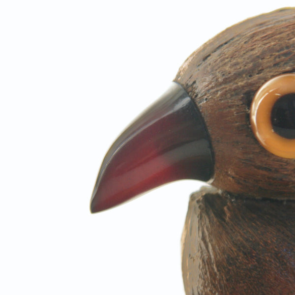 Close-up of a YZ bird figurine with a detailed red cherry amber bakelite Faturan beak. Produced by Henry Howell & Co. for Dunhill.