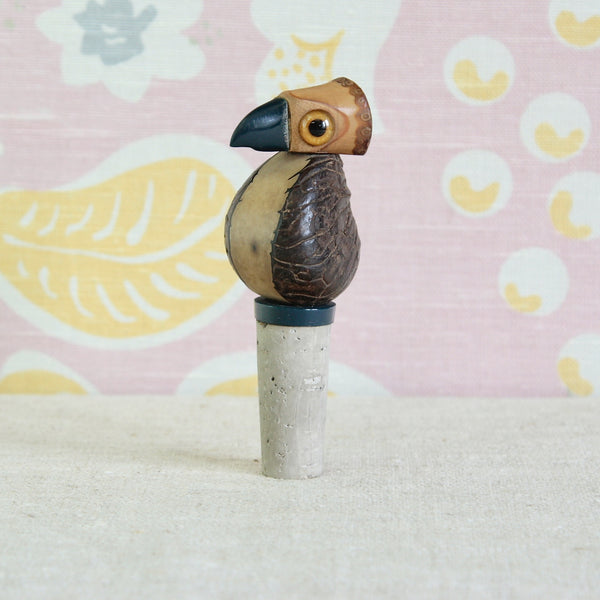 Close-up of the YZ Nut Bird showing the tagua nut body, rattan head and cased glass eyes