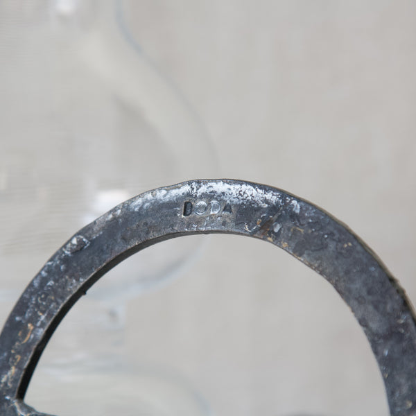 Detailed close up showing the makers mark on the underside of a Bertil Vallien candelabrum. The stamp of the manufacturer reads 'BODA' for Boda Smide.