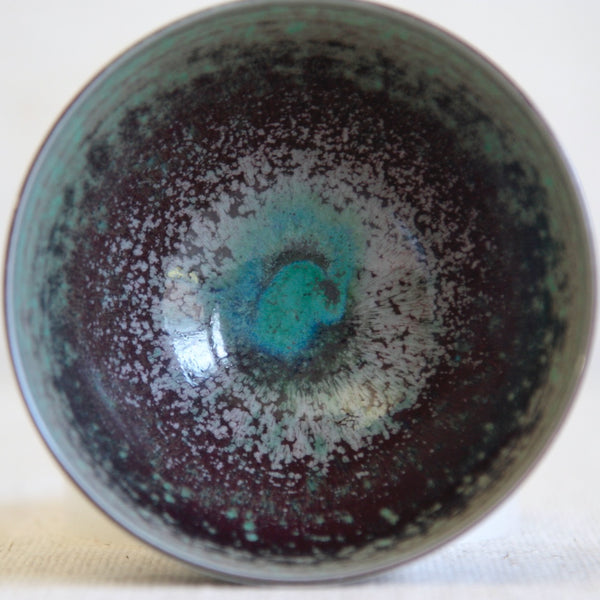 Close-up of a Berndt Friberg ceramic bowl with speckled celestial, galaxy-style glaze; an outstanding example of 20th-century Scandinavian studio pottery.