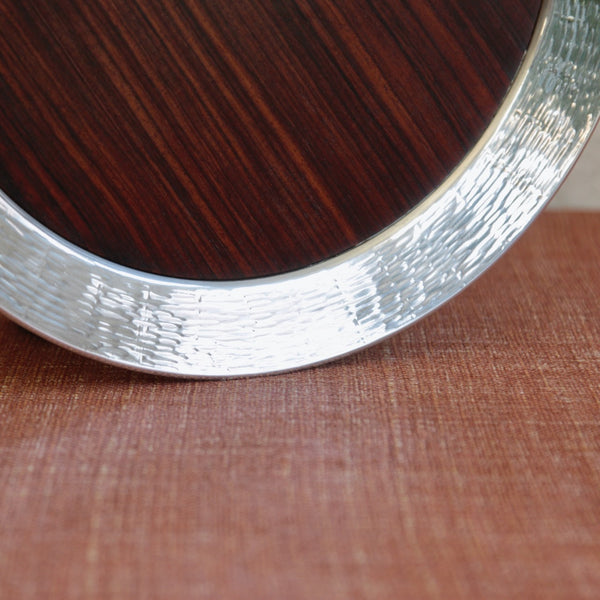 Circular Tapio Wirkkala tray with deep silver collar and richly figured ebony wood
