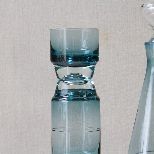 Close up of a Paraati drinking glass design by Nnnay Still and made by Riihimaki Glassworks. The glass is cased, clear over steel blue.