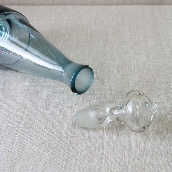 Action image showing the decanter stopper falling out of a 'Paraati' decanter bottle designed by Nanny Still for Riihimaki glassworks, Finland