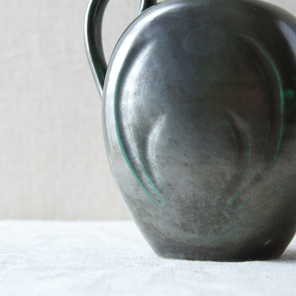 Close up showing the incised simple pattern on the side of a Harald Östergren Upsala Ekeby ceramic vase produced in the 1920s.