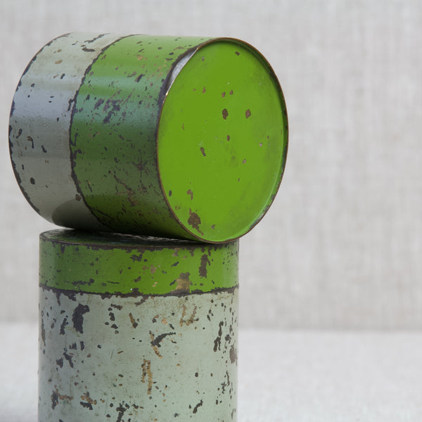 Detail showing the underside of a small colourfully enamelled tin balancing atop a similar storage jar by the same maker. The superb collectable early twentieth century industrial antiques are similar to the work of Hans Przyrembel.