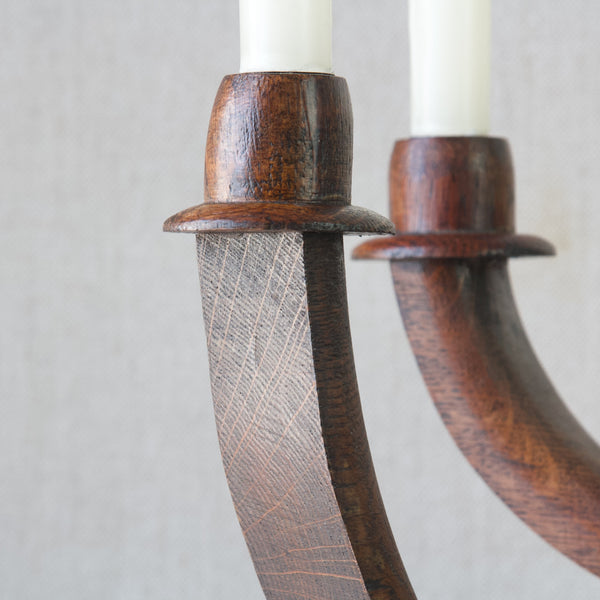 Detail of candle sconce on antique handmade rustic oak candelabra 
