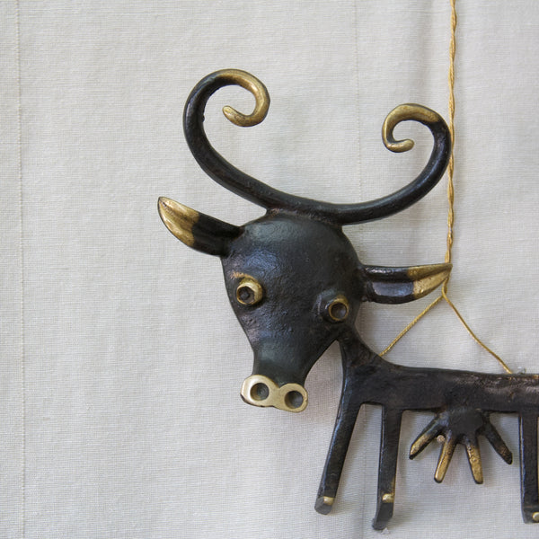 Detail of Walter Bosse characterful face of a large cow key rack or holder. The cow is patinated brass with large horns and eyes.