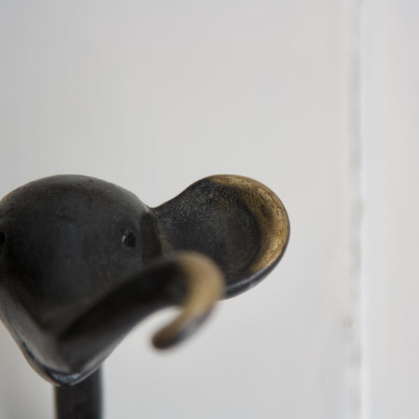 Detail of patinated and polished elephant head on Walter Bosse vintage coat hook design