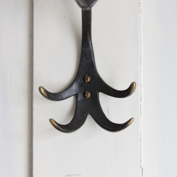 Detail of Walter Bosse modernist metal coat hook in the shape of an elephant showing patinated arms with polished tips