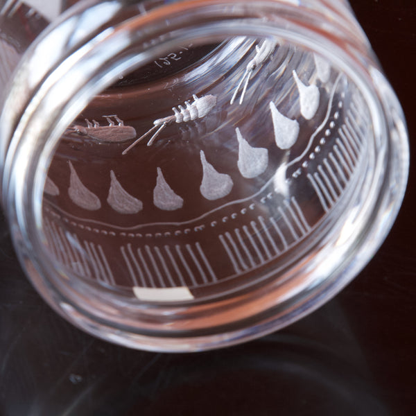detail shot of engraved abstract tribal pattern on swedish glass vase from boda designed by erik hoglund 1955