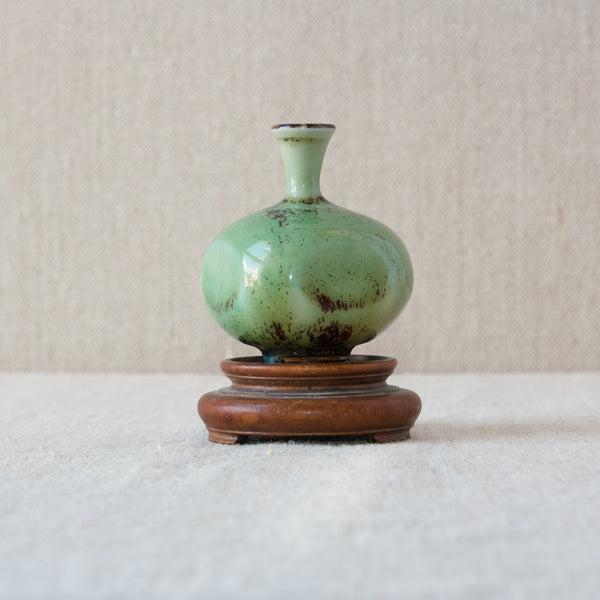 A Berndt Friberg vase designed for Gustavsberg stood atop an antique turned wood base.