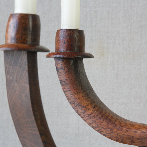 Detail of candle sconce and wood grain on antique handmade rustic oak candelabra