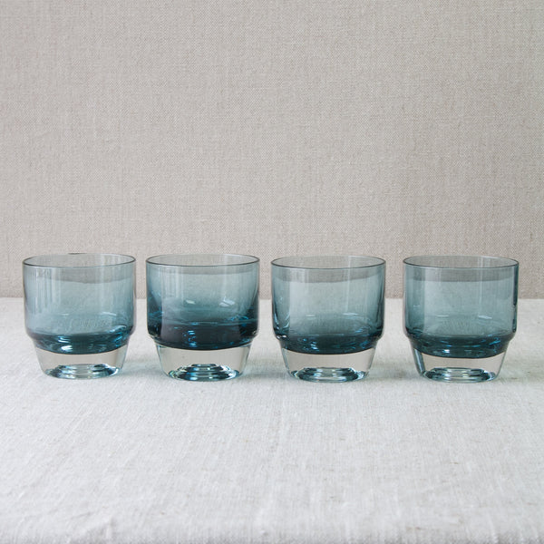 Four Paraati Series glasses by Nanny Still. The glasses are cased in clear glass, and are reassuringly heavy in the hand. They each feature the distinctive 'sun rings' whilst their shape reflects the decanter's shouldered form.
