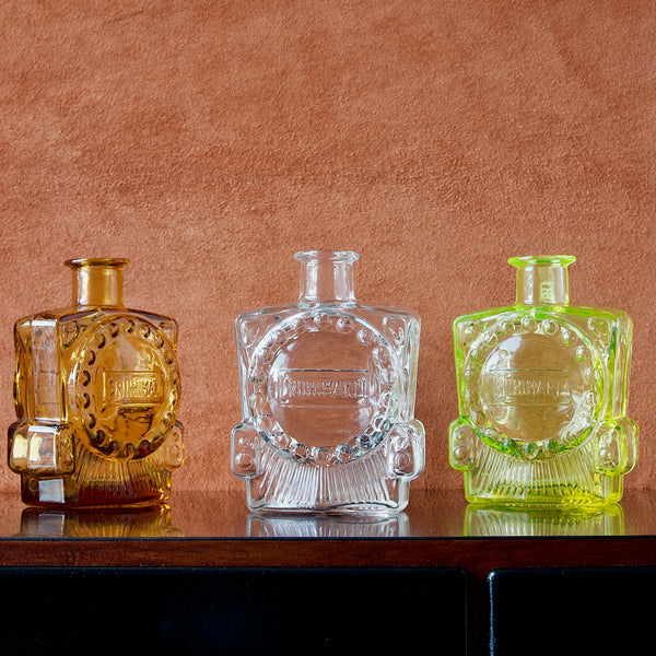 A group of Riihimaki Locomotive bottle vases by Erkkitapio Siiroinen in clear glass, amber, and uranium