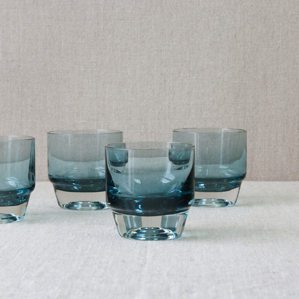 A set of four steel blue coloured glass 'Paraati' (Parade) drinking glasses suitable for whiskey and other short drinks designed by Nanny Still for Riihimaki glassworks, 1965