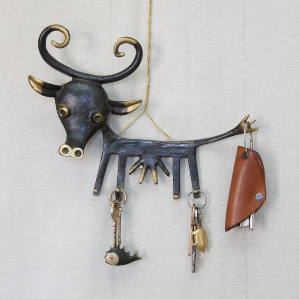 Modern Vienna Bronze Large Walter Bosse key rack holder, designed and produced around 1960. The cow-shaped, black patinated brass key holder features large horns and has keys hanging from the feet, including a Carl Aubock pig keyring and Bosse fish keyring