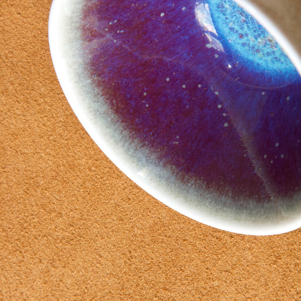 Purple glaze detail on Swedish ceramic bowl designed by Carl Harry Stalhane 