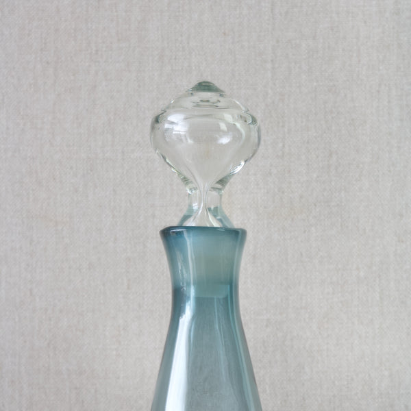 Straight on shot of the clear glass stopper in a steal blue coloured 'Paraati' (Parade) decanter designed by Nanny Still in 1965 for Riihimaki glassworks