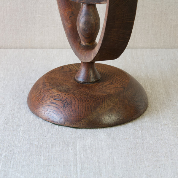 Detail of oak base on antique four-armed handmade candelabra, made from English oak wood