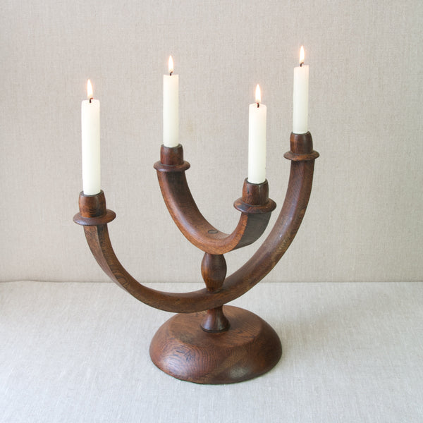 Antique folk art candelabra centrepiece with four arms, made from English oak wood in around 1920, providing a classic cottage aesthetic.