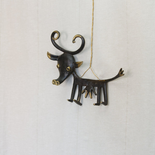 Whimsical black metal cowl key holder or rack in the shape of a cartoon cow designed by Walter Bosse