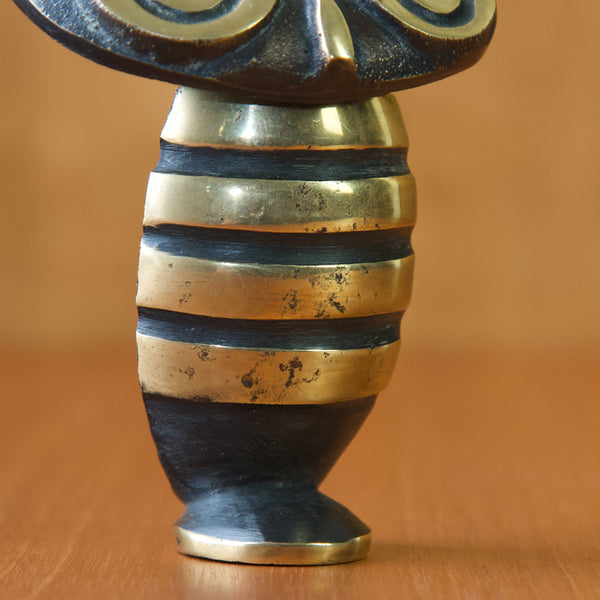 Close up showing the age related wear and patination on the polished stripes on the belly of a vintage 1950s owl shaped corkscrew. This large and unusual work is a rare example of Walter Bosse design.